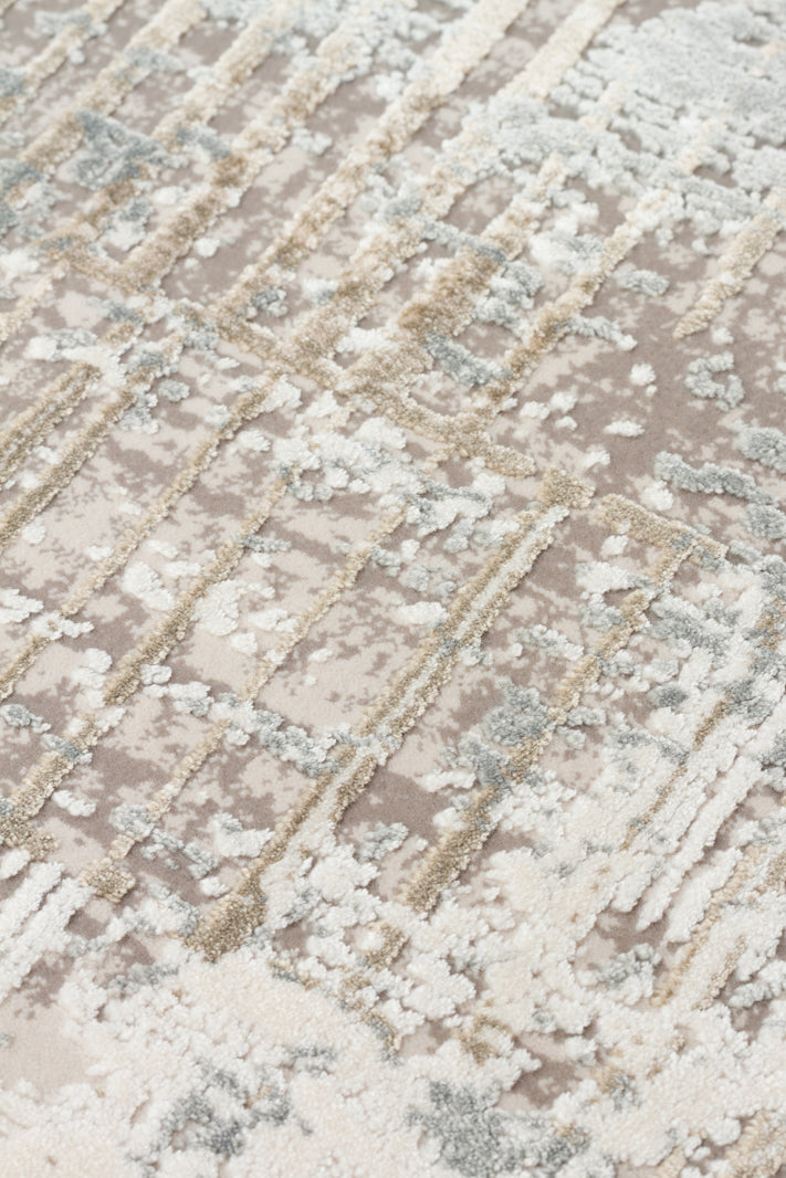 Taupe, cream, and grey rug with a high-low pile, featuring a distressed geometric grid pattern.