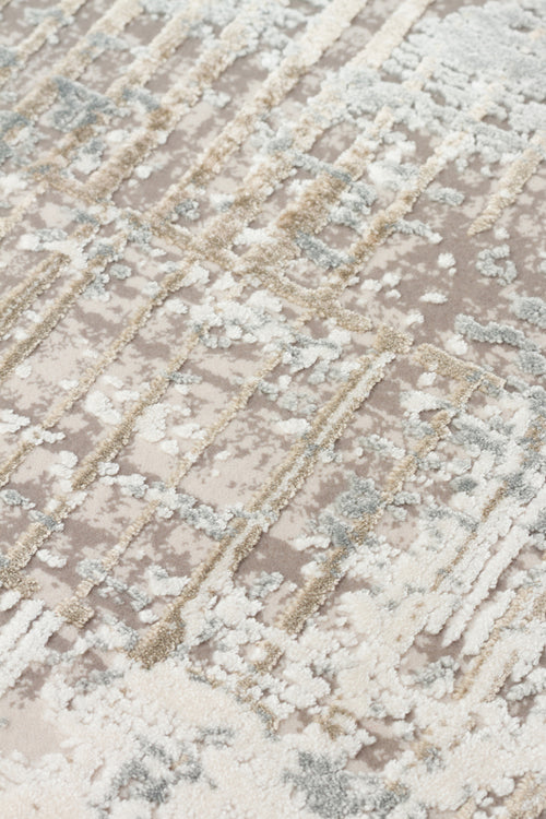 Load image 1 in gallery view. Taupe, cream, and grey rug with a high-low pile, featuring a distressed geometric grid pattern.