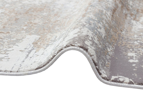 Load image 1 in gallery view. Grey, beige, and white abstract distressed rug with a serged edge, shown on a white background.