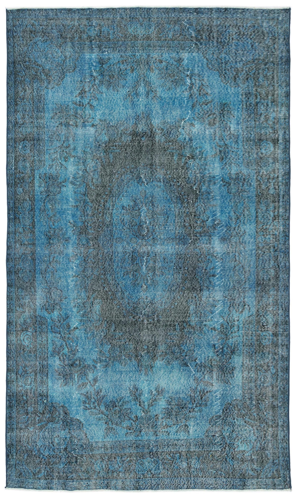 Distressed blue and charcoal area rug with a faded traditional medallion pattern and a bordered edge.