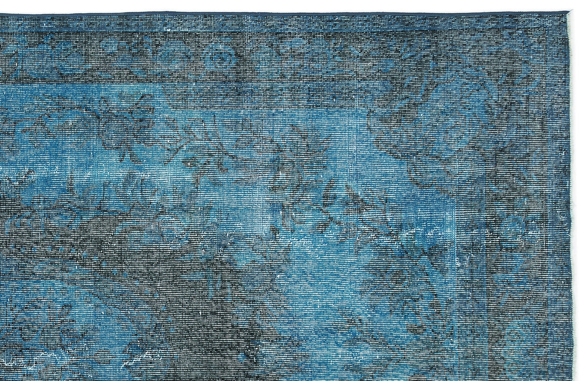 Deep blue and black distressed rug with a faded traditional floral medallion pattern.