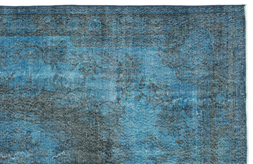 Load image 1 in gallery view. Deep blue and black distressed rug with a faded traditional floral medallion pattern.