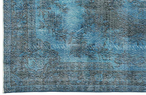 Load image 1 in gallery view. Deep blue and black distressed rug with a faded traditional floral medallion pattern.
