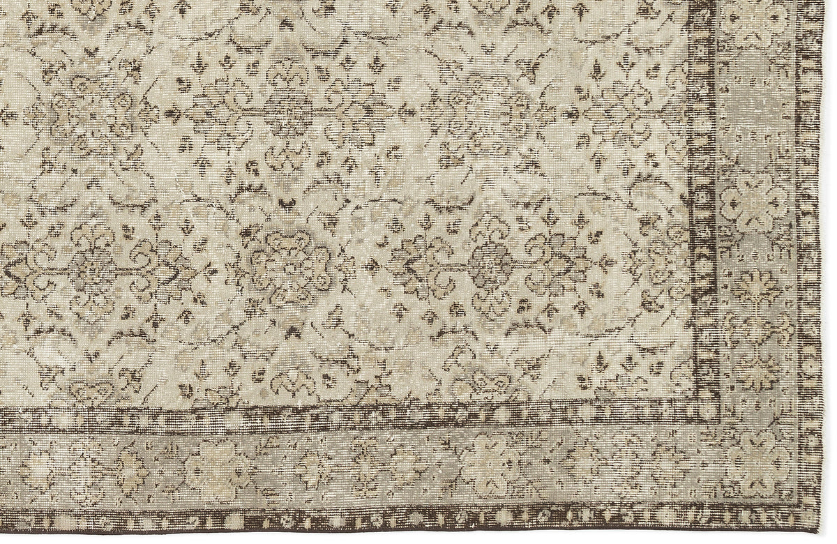 The Kemora - Vintage Floral Rug (4'10 x 8'6) features a beige flatwoven base with intricate floral and vine patterns, a darker beige border with delicate floral motifs, and a design inspired by Anatolian heritage rugs.