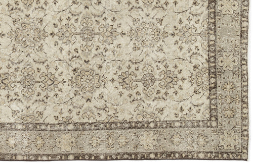 Load image 1 in gallery view. The Kemora - Vintage Floral Rug (4'10 x 8'6) features a beige flatwoven base with intricate floral and vine patterns, a darker beige border with delicate floral motifs, and a design inspired by Anatolian heritage rugs.