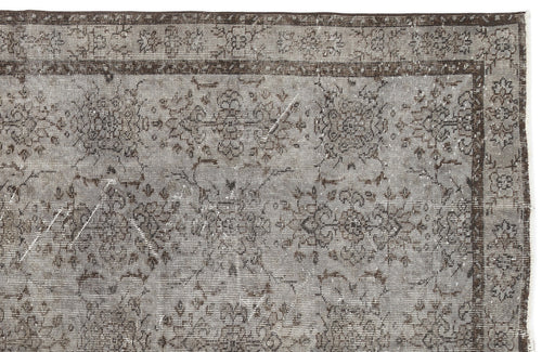 Load image 1 in gallery view. Grey and dark brown distressed rug with a traditional floral medallion pattern and a detailed border.