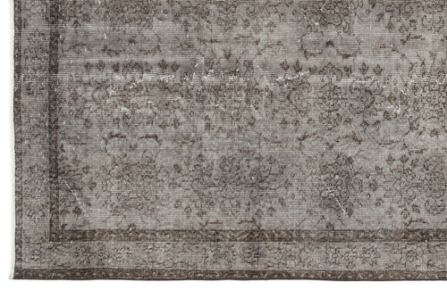 Load image 1 in gallery view. Grey and charcoal distressed rug with a faded traditional floral medallion pattern and a dark border.