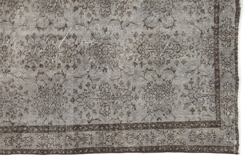 Load image 1 in gallery view. Grey and brown distressed rug with a traditional floral medallion pattern and a wide decorative border.