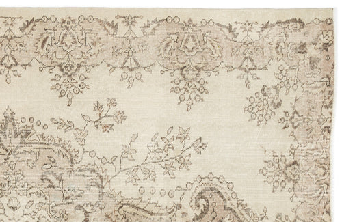 Load image 1 in gallery view. Beige and taupe vintage-style rug with a faded floral and paisley pattern on a white background.