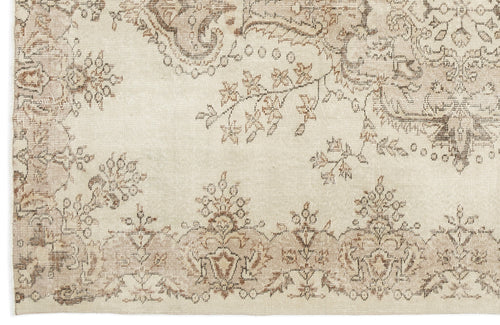 Load image 1 in gallery view. Cream rug with a distressed brown floral medallion pattern and intricate botanical border.
