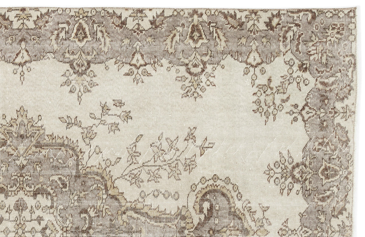 The Luboane Vintage Medallion Rug (6'1 x 9'1) features an intricate, faded floral and geometric pattern in beige, brown, and cream with ornate border detailing for a timeless vintage look.