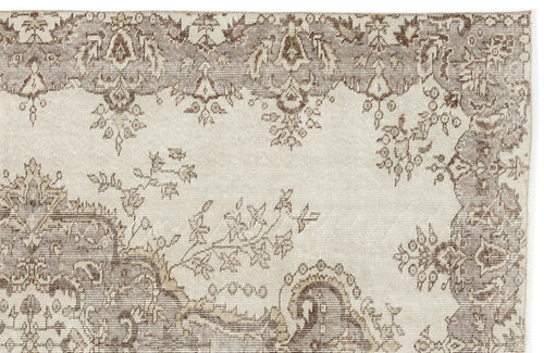 Load image 1 in gallery view. The Luboane Vintage Medallion Rug (6'1 x 9'1) features an intricate, faded floral and geometric pattern in beige, brown, and cream with ornate border detailing for a timeless vintage look.