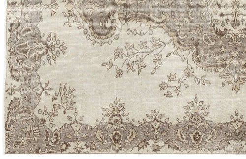 Load image 1 in gallery view. A close-up of the Luboane - Vintage Medallion Rug (6'1 X 9'1) shows its beige and taupe palette, ornate border, floral motifs, and a faded Anatolian-inspired vintage look.
