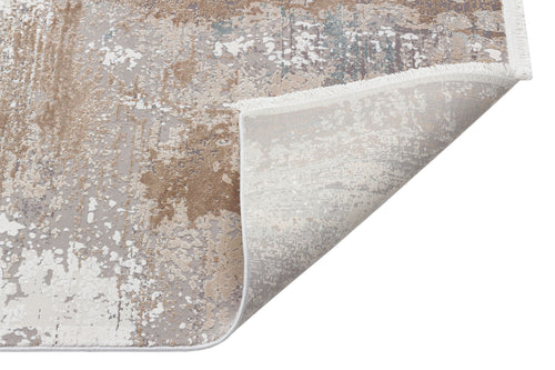Load image 1 in gallery view. Taupe, grey, and white abstract distressed rug with a folded corner showing the underside and fringe.