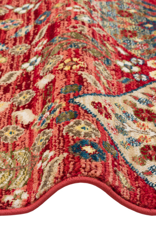 Load image 1 in gallery view. Red traditional rug with a multi-colored floral medallion pattern and a textured, folded edge.