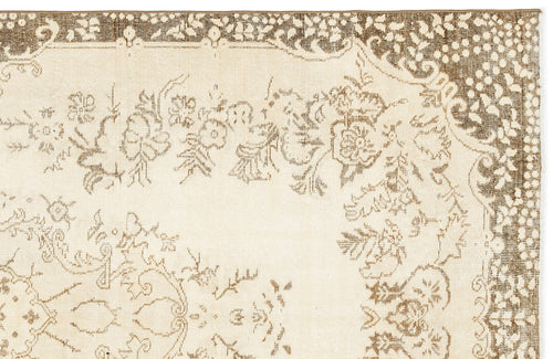 Load image 1 in gallery view. Cream rug with a brown floral medallion pattern and a detailed botanical border.