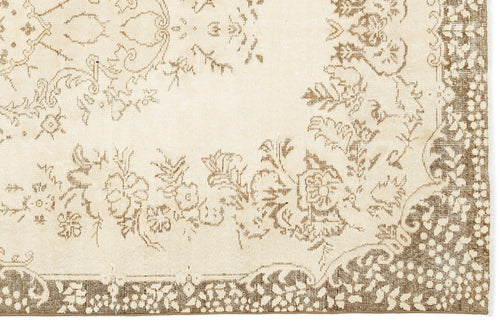 Load image 1 in gallery view. Cream and brown rug with a distressed floral medallion pattern and a detailed botanical border.