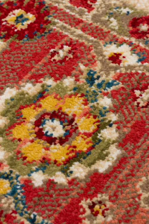 Load image 1 in gallery view. Close-up of a traditional rug with a red, yellow, green, and blue floral medallion pattern on a textured pile.