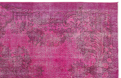 Load image 1 in gallery view. Magenta distressed rug with a faded dark floral medallion pattern on a white background.