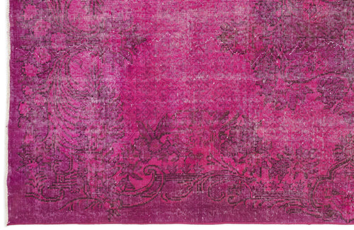 Load image 1 in gallery view. Magenta distressed rug with a dark floral medallion pattern and white fringe edge.