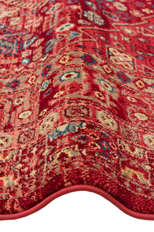 Load image 1 in gallery view. Red traditional rug with a distressed Persian-style pattern in blue, beige, and yellow accents.