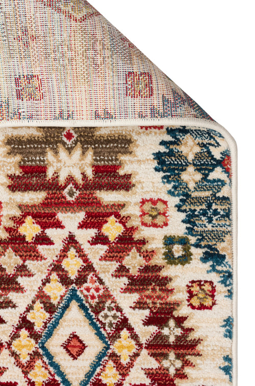 Load image 1 in gallery view. Cream-colored rug with a multi-colored geometric tribal pattern in red, blue, and yellow, shown with a folded corner.