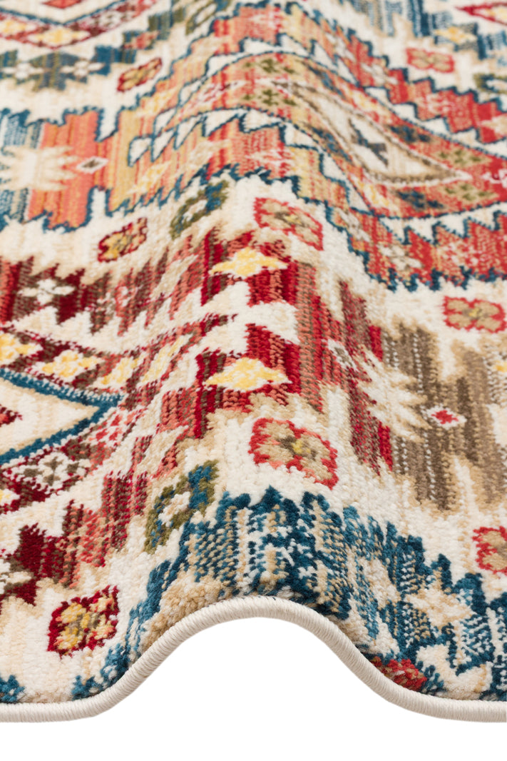 Cream rug with a multi-colored traditional Persian-style pattern in red, blue, and yellow, shown folded.