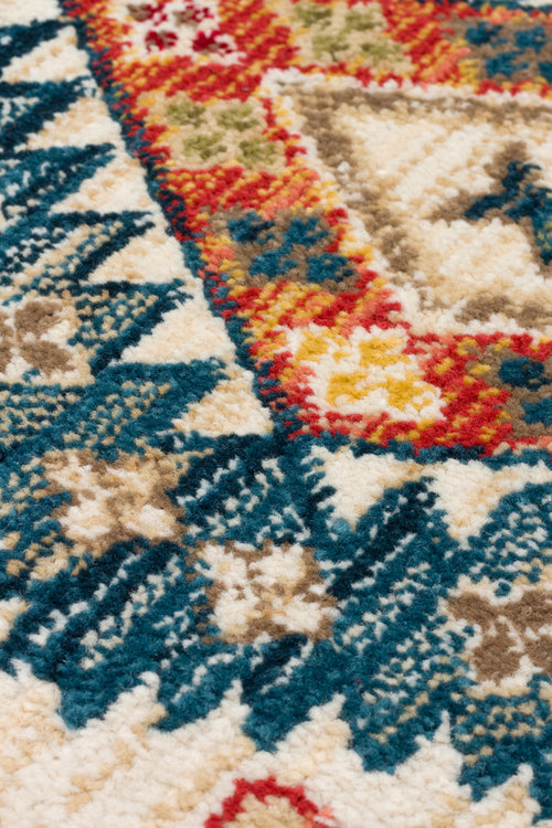 Load image 1 in gallery view. Close-up of a high-pile rug featuring a traditional medallion pattern in teal, red, yellow, and beige.