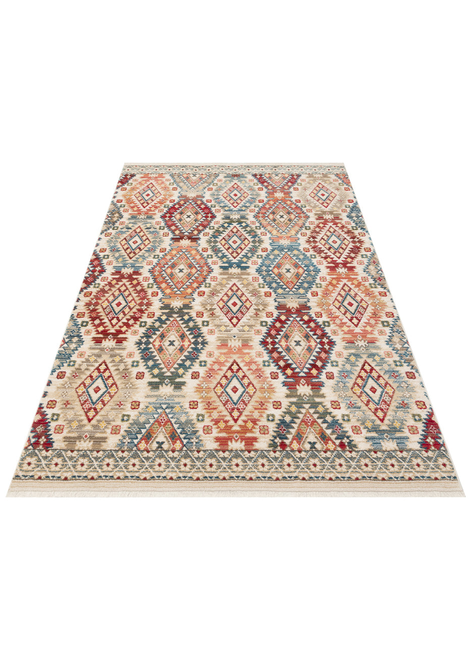 Cream rug with a multi-colored geometric diamond pattern in red, blue, and tan, featuring a fringed border.