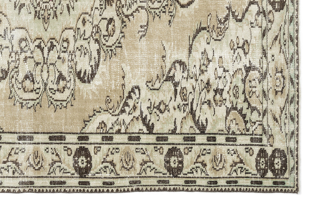 A close-up of the Vaerail Vintage Medallion Rug (6'3" x 8'9") in beige and cream, showcasing an ornate floral and vine pattern with a decorative border of circular floral motifs.