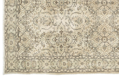Load image 1 in gallery view. Beige and taupe traditional rug with a distressed floral medallion pattern and a fringed border.