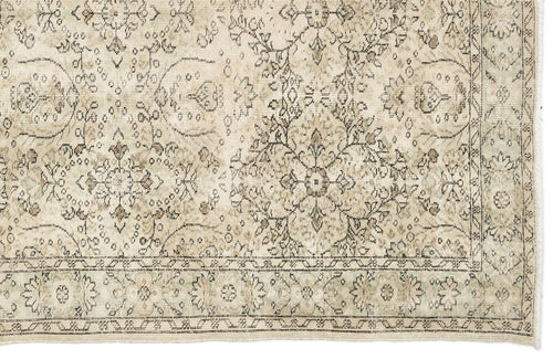 Load image 1 in gallery view. Beige and taupe vintage-style rug with a distressed floral medallion pattern and a decorative border.