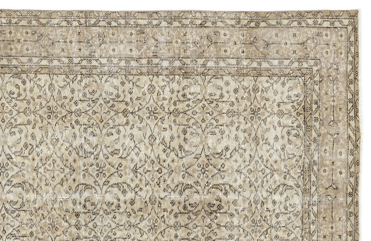 A close-up of the Coaluon - Vintage Floral Rug - 5'8 X 9'1 showcases its flatwoven build, ornate beige and light brown floral and vine motifs, a decorative border, and gentle fading that highlights its Anatolian-inspired vintage charm.
