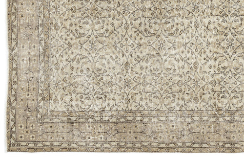 Bild 1 in Galerieansicht laden. A close-up of the Coaluon - Vintage Floral Rug (5'8 x 9'1) shows beige and taupe tones with an intricate floral and geometric pattern, a detailed border, and a soft, worn texture that reflects its Anatolian heritage.