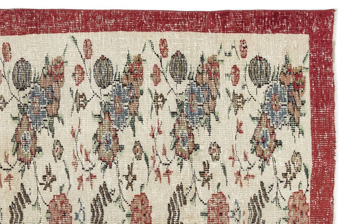 Load image 1 in gallery view. Cream rug with a distressed red border and a repeating floral pattern in muted red, blue, and green tones.