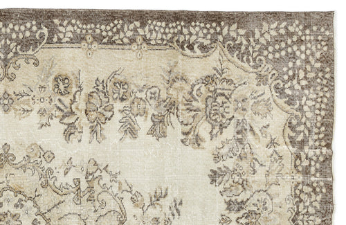 Load image 1 in gallery view. Beige and brown rug with a distressed traditional floral medallion pattern and ornate border.