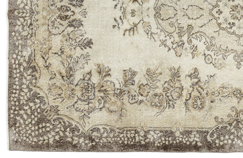 Load image 1 in gallery view. Beige and brown rug with a distressed floral medallion pattern and a decorative border.
