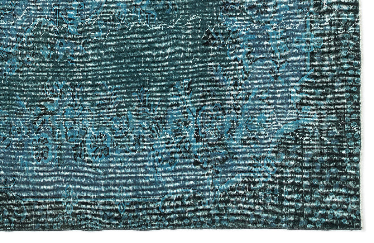 Teal and black distressed rug with a traditional floral medallion pattern on a white background.