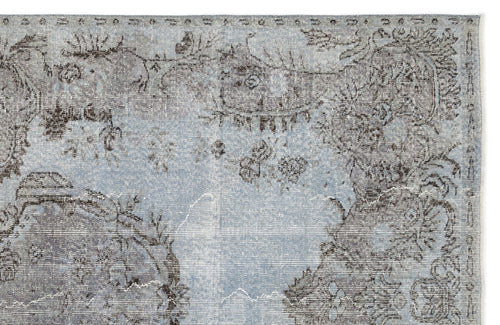 Load image 1 in gallery view. Light blue and charcoal grey rug with a distressed, traditional floral medallion pattern.