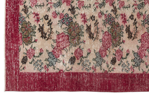 Load image 1 in gallery view. Distressed beige rug with a red floral pattern and a solid red border.