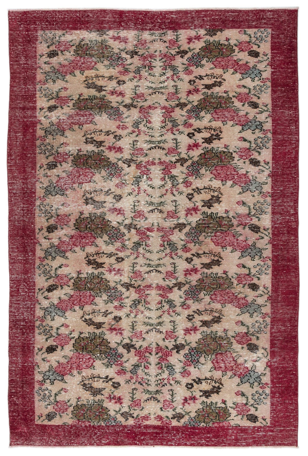 Distressed beige rug with a deep red border and a repeating floral medallion pattern in pink, olive, and grey.