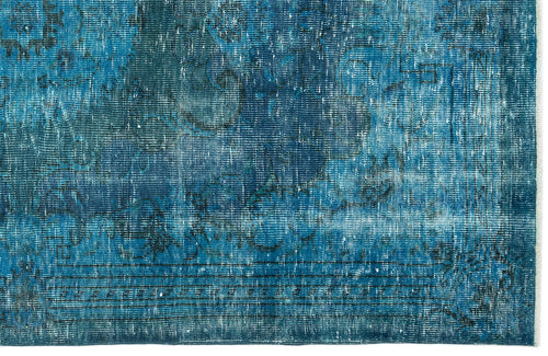 Load image 1 in gallery view. Deep blue distressed rug with a faded traditional medallion pattern and a fringed edge.