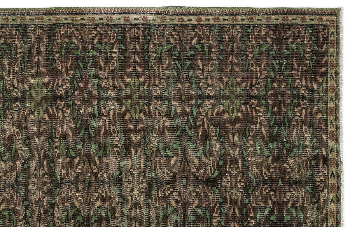 Dark brown traditional rug with a repeating floral vine pattern in olive green and tan, featuring a detailed border.