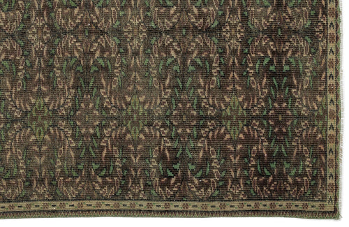 Load image 1 in gallery view. Dark brown and green traditional rug with a repeating floral medallion pattern and a narrow geometric border.