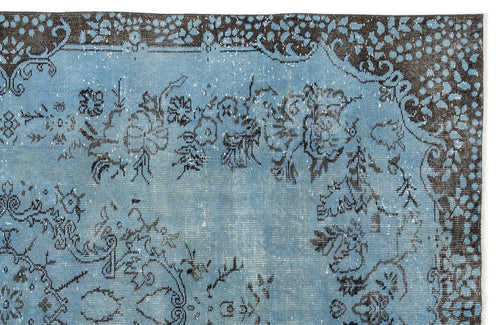 Load image 1 in gallery view. Distressed light blue rug with a dark brown floral border and central medallion pattern on a white background.