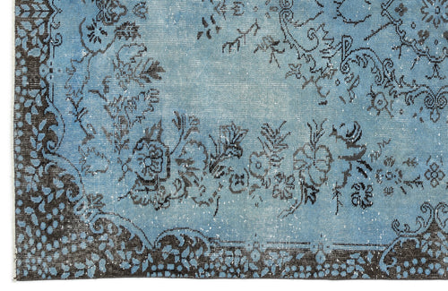 Load image 1 in gallery view. Distressed light blue rug with a dark charcoal floral medallion pattern and a decorative border.