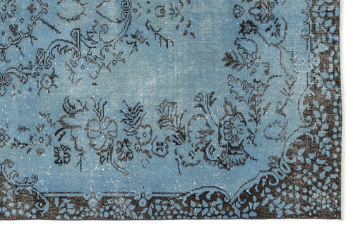 Load image 1 in gallery view. Distressed light blue rug with a dark charcoal floral medallion pattern and a detailed border.