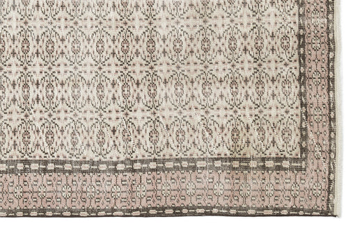 Load image 1 in gallery view. Beige and dusty rose rug with a repeating geometric medallion pattern and a dark brown border.