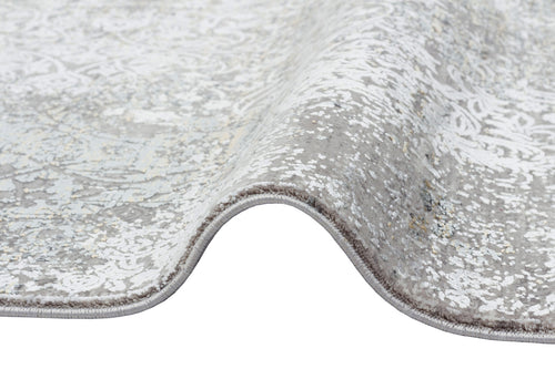 Bild 1 in Galerieansicht laden. Grey and white rug with a distressed traditional medallion pattern and a serged edge, shown folded on a white background.