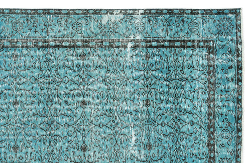 Load image 1 in gallery view. Turquoise and black distressed rug with a traditional ornate floral medallion pattern and a geometric border.